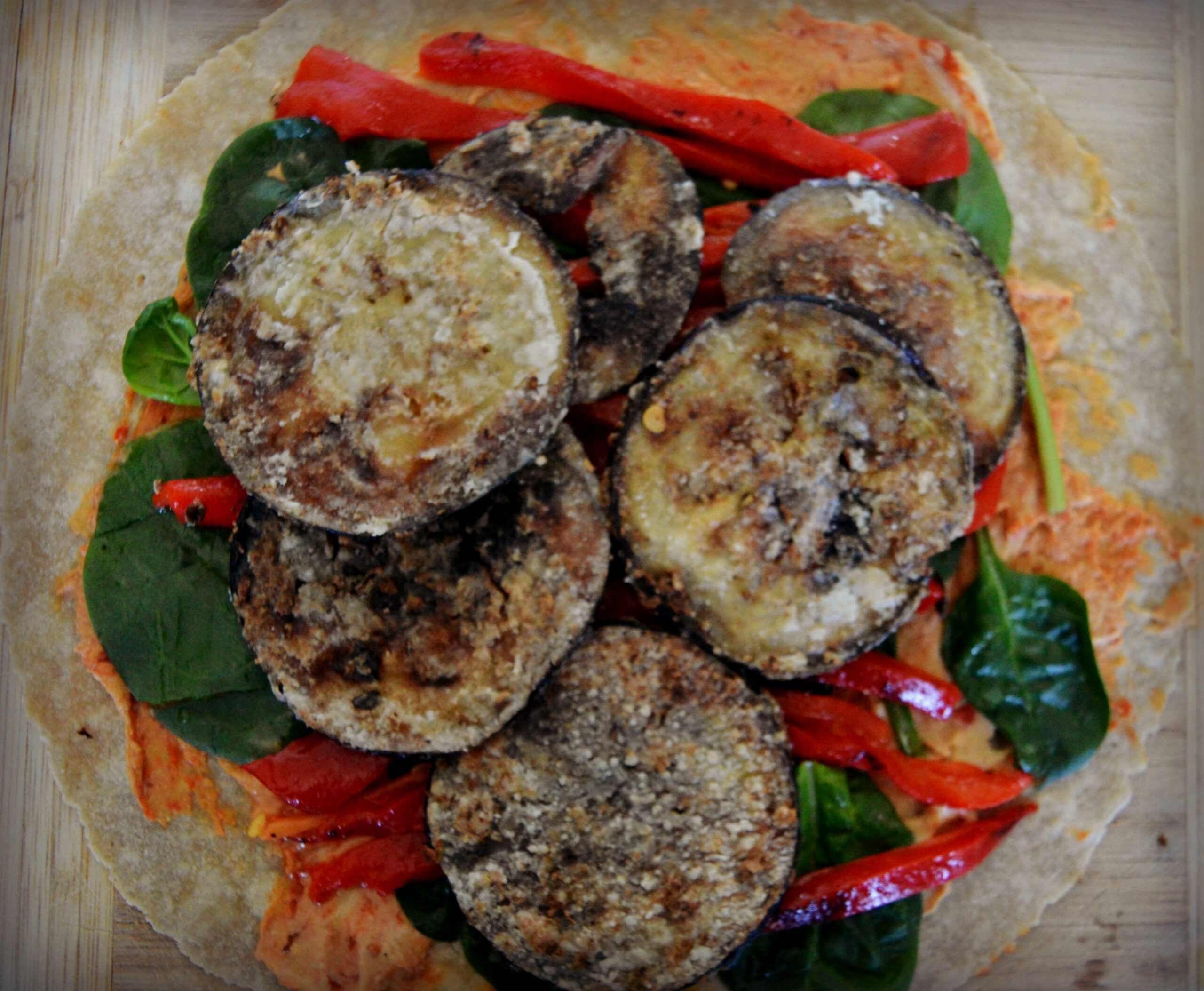 This Crispy Eggplant and Roasted Pepper Wrap is a fantastic combination of flavors. A light coating of corn starch gets the eggplant