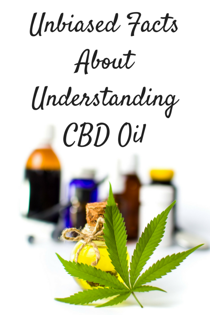 CBD leaf on white table with oil container behind it